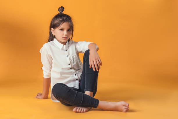 istock child in the Studio posing in fashionable clothes 1007919200