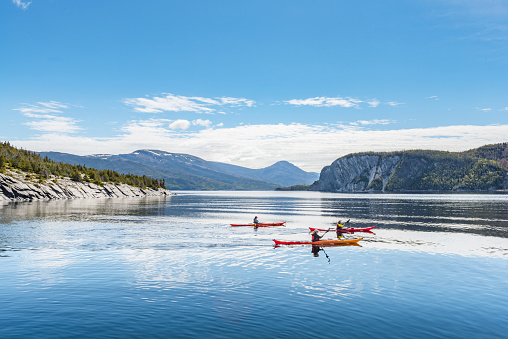 Newfoundland, Canada - June 12, 2018: Some travelers are playing kayaks in Norris\nCove of Norris Point, NF Canada.