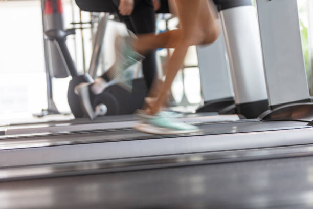istock Blurred motion of people jogging on treadmill 1007928570
