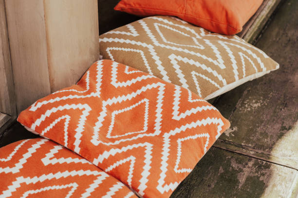 Orange cafe pillows on the desk closeup. Cafe exterior and interior. stock photo