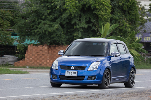 Chiangmai, Thailand - July  13 2018: Private Eco city Car Suzuki Swift. Photo at road no.121 about 8 km from downtown Chiangmai, thailand.