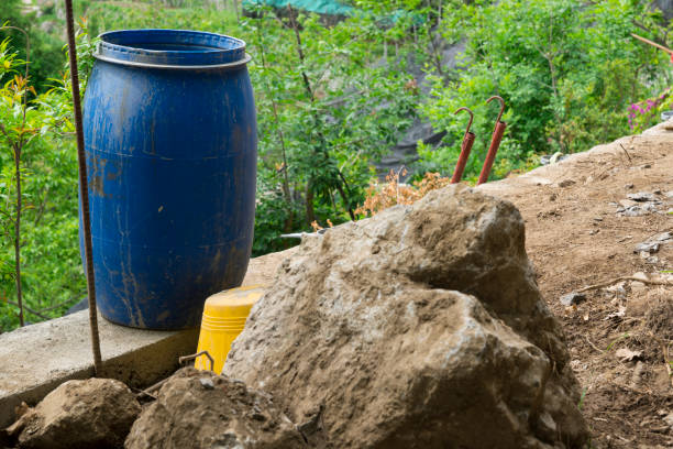 istock blue plastic trash bin and yellow metal bucket in garden 1007949934