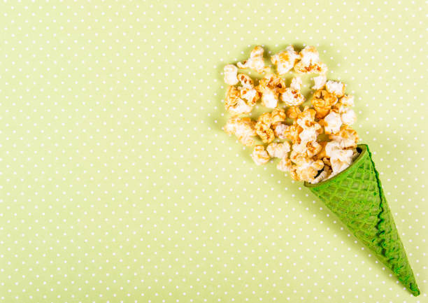 istock Popcorn with caramel  on the table. Popcorn and green waffle. Top view. Copy space. 1007950096