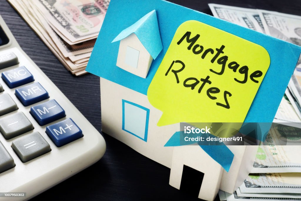 Mortgage rates written on a model of house. Interest Rate Stock Photo
