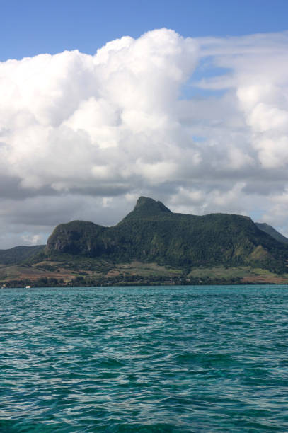 istock Volcano rising above turqouis, crystal clear water: Mauritius 1007950468