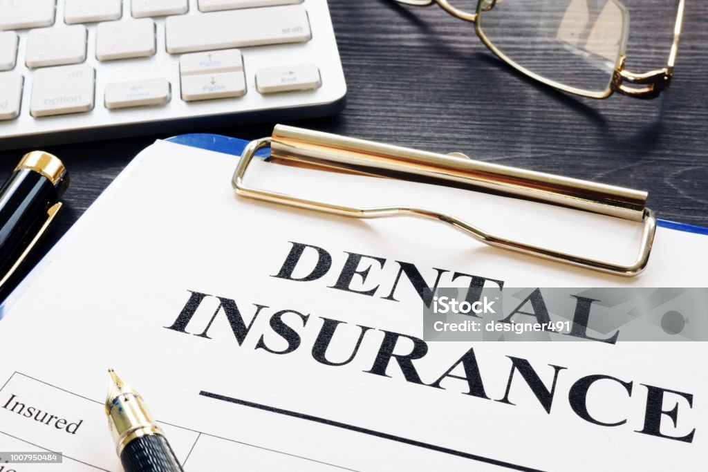 Dental insurance form and pen on a desk. Dental Health Stock Photo