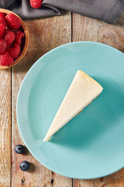 istock Classic Plain New York Cheesecake on Blue Plate 1007957070