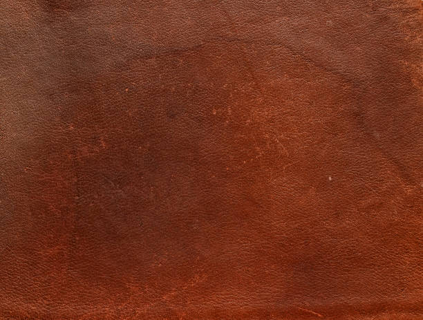 istock Texture of old shabby brown genuine cow leather 1007957444