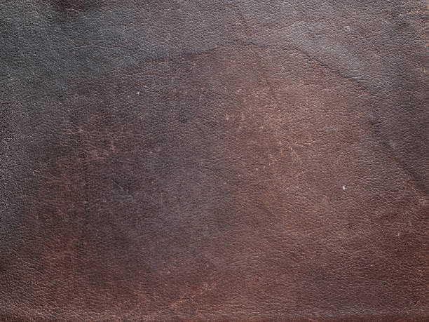 istock Texture of old shabby brown genuine cow leather 1007957448