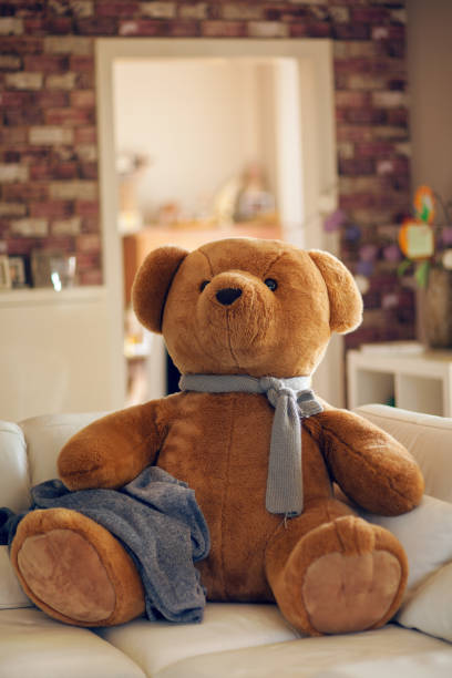istock huge teddy bear is sitting on the couch 1007967588