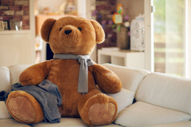 huge teddy bear is sitting on the couch