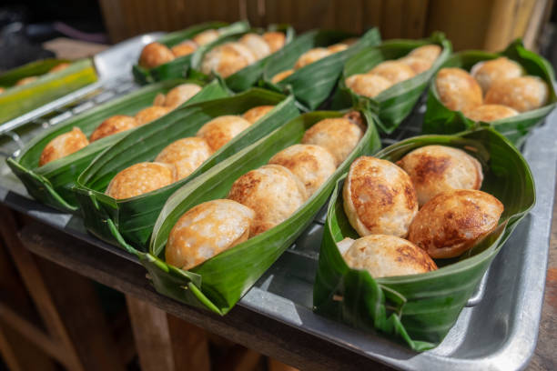 istock Thai sweetmeat khanomkhrok banana leaf package 1007968174
