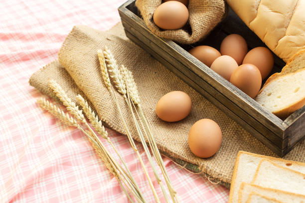 istock breakfast and baked bread concept. Fresh fragrant bread and egg on the fabric sack. On wooden table. 1007970678