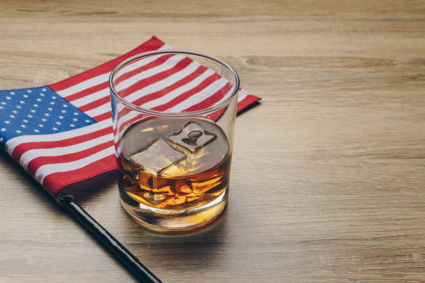 close up of a glass of bourbon whiskey - flag glass striped fourth of july imagens e fotografias de stock