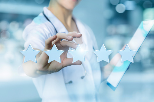 Health worker puts the rating stars on blurred background.