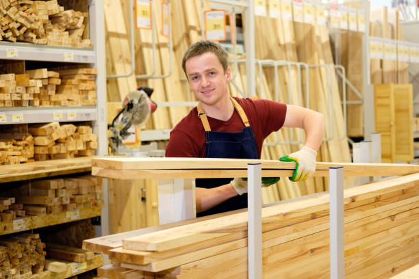 istock worker or seller in construction store or warehouse wood section at work 1007987180