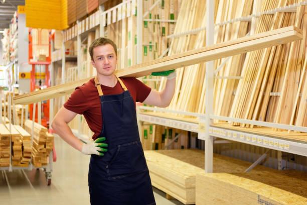 istock worker or seller in construction store or warehouse wood section at work 1007987192