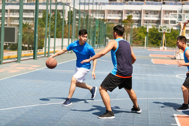 istock asian young adult playing basketball 1007990318
