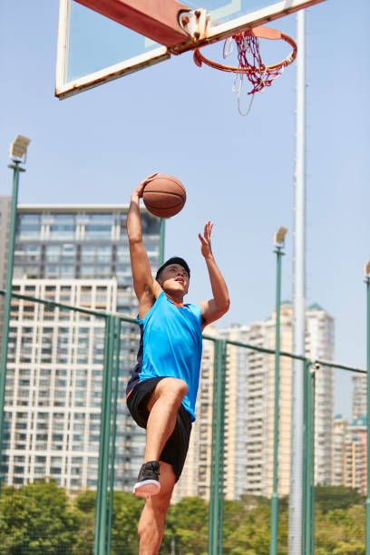 istock young asian basketball player dunking 1007990480