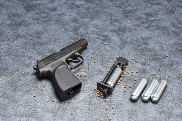 istock Pneumatic pistol on a grey background 1007990602