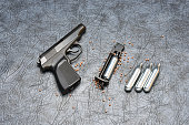 Pneumatic pistol on a grey background