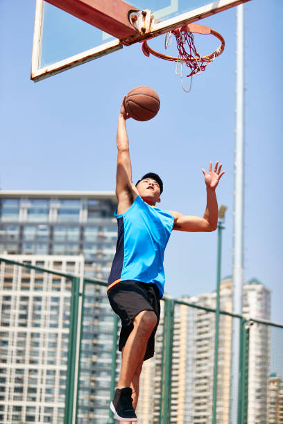 istock young asian basketball player dunking 1007990920