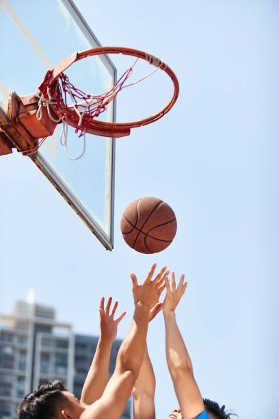 istock young asian adults playing basketball 1007991018
