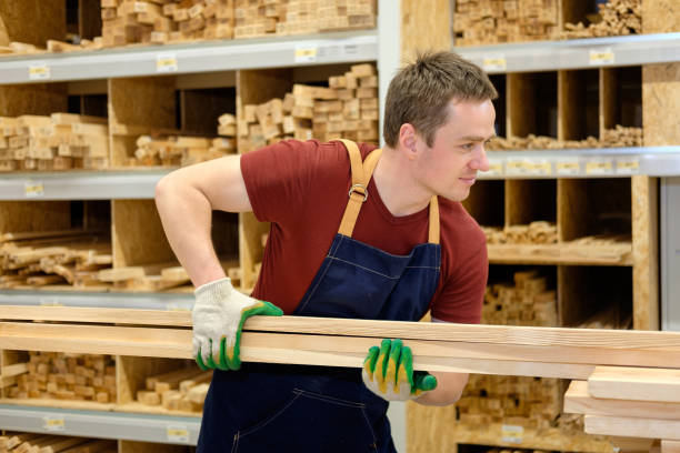 istock worker or seller in construction store or warehouse wood section at work 1007991128