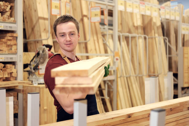 istock worker or seller in construction store or warehouse wood section at work, tonned 1007991132