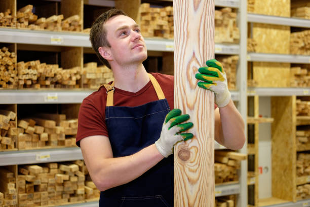 istock worker or seller in construction store or warehouse wood section at work 1007991138