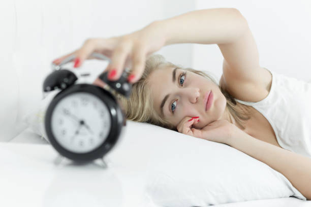 istock Woman annoyed by alarm clock 1007991322