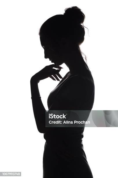 Silhouette Profile Of A Sad Woman With Hand Near Chin On A White Isolated Background Stock Photo - Download Image Now