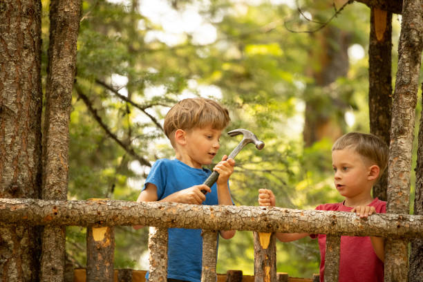 building tree house Boys in tree house having fun. playhouse stock pictures, royalty-free photos & images