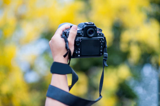 istock Hand and camera and travel 1007997196