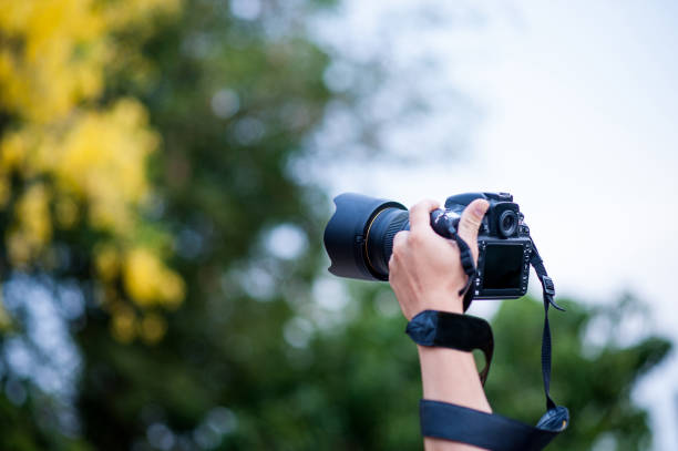 istock Hand and camera and travel 1007997210