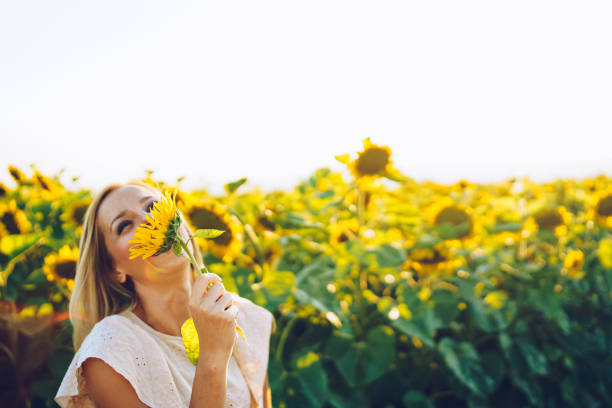 istock happy woman in sunflower field 1008030304