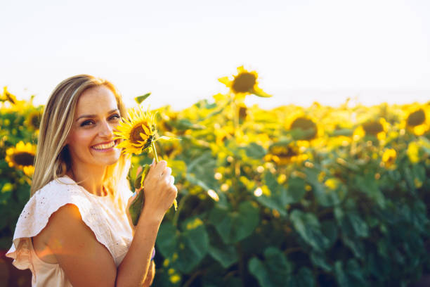 istock happy woman in sunflower field 1008030334