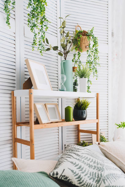 istock Cozy brightly lit room corner decorated with various objects such as picture frames, plants and pillows, vertical image 1008030498