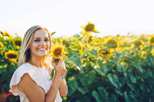 istock happy woman in sunflower field 1008030528