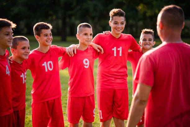 istock Soccer players standing and listening a coach 1008049634