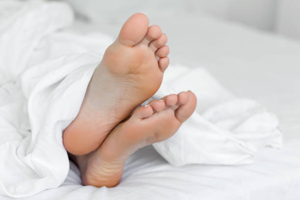istock Woman foot on bed 1008052456