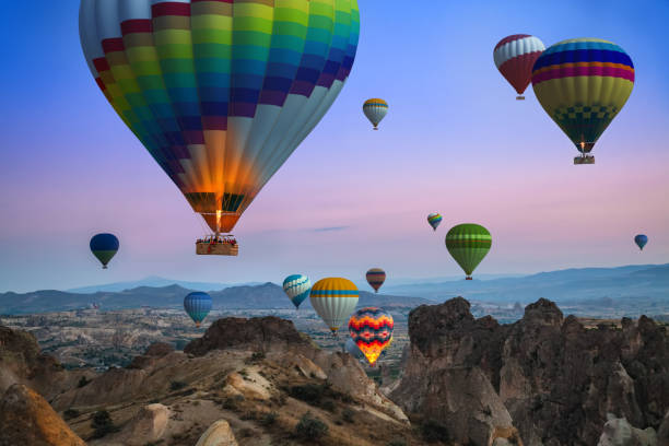 Cappadocia Balloon Tour Sunrise in Cappadocia, about hundreds of colorful balloons rising into the sky. Wonderful view. rock hoodoo stock pictures, royalty-free photos & images
