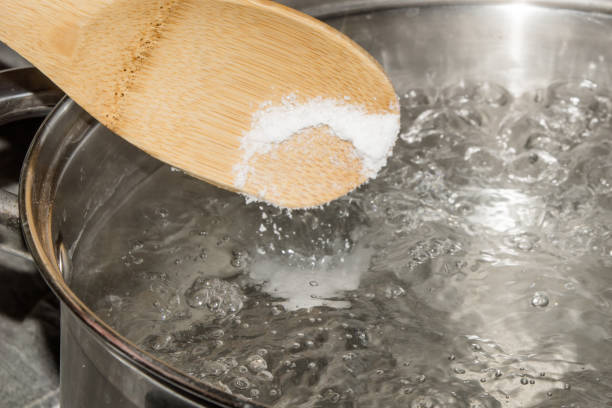 istock In boiling water pour salt with a wooden spoon. 1008064892