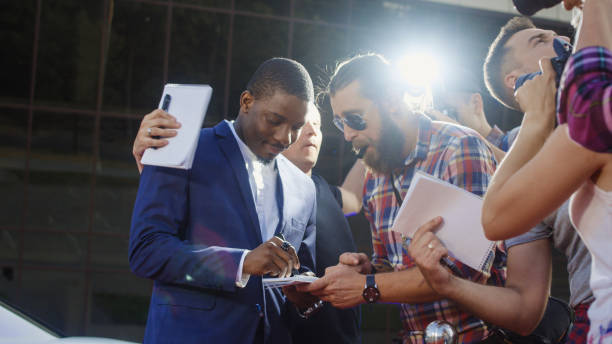 Famous ethnic actor giving autographs