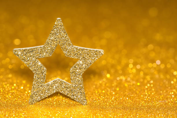 istock Shining star on a golden radiant background. Glitter shine with 3d shape 1008080622