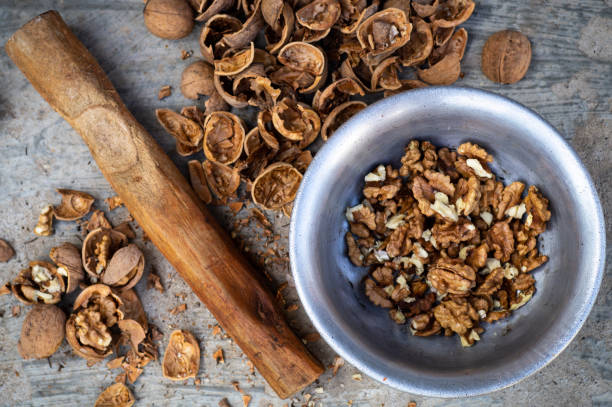 istock Walnuts kernels with color background, Whole walnut in a metal plate. Walnuts. Walnuts an market. Background of walnuts. Healthy. 1008088496