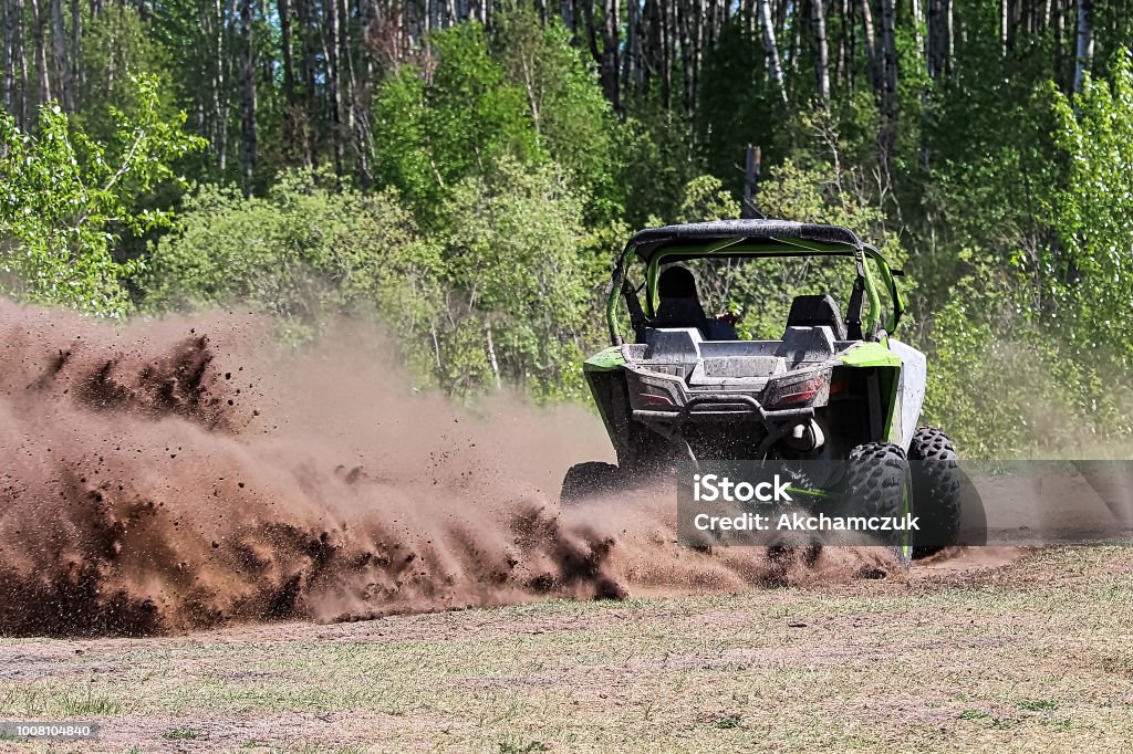 A side-by-side ripping up dirt as it turns a corner A side-by-side ripping up dirt as it turns a corner. Off-Road Vehicle Stock Photo