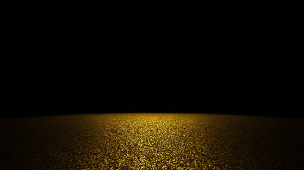 istock twinkling golden glitter on a flat surface  lit by a bright spotlight (on black background) 1008105112