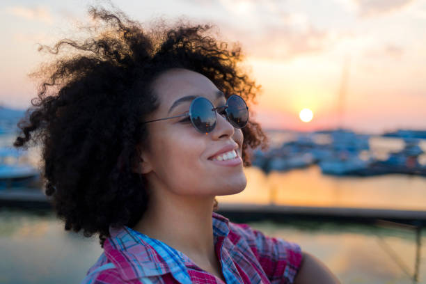 istock Young woman having fun at sunset 1008105330