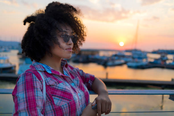 istock Young woman having fun at sunset 1008105358